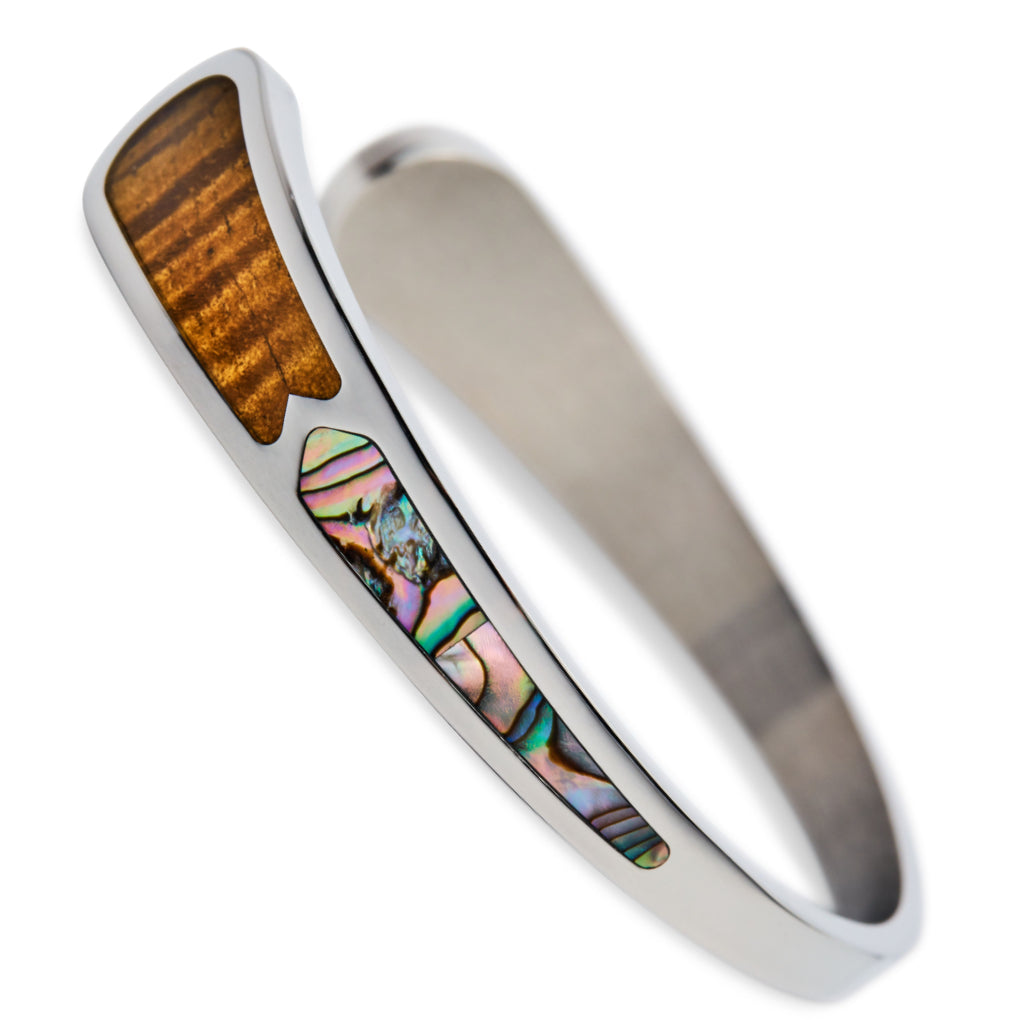 koa wood and abalone cuff closeup focusing on the abalone inlay