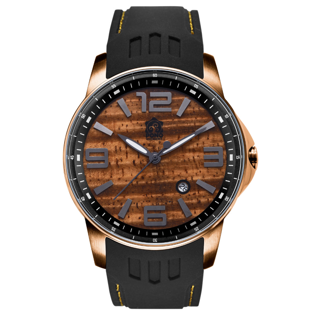 closeup showing gold color version Surfrider Koa wood watch highlighting design details of wave crown, surfboard shaped hands, black silicone band