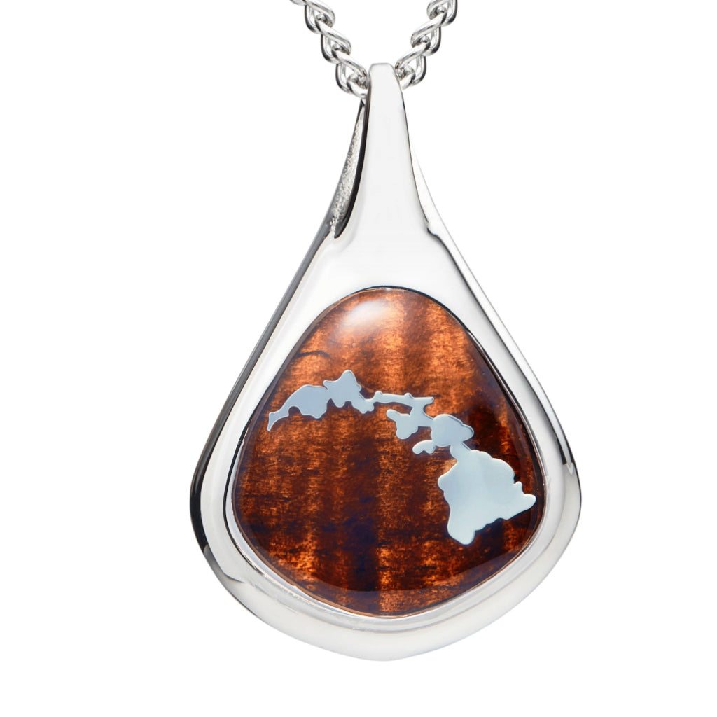koa wood inlay pendant with tear drop shape and crashing wave bail shape, Silver islands design overlaid the koa