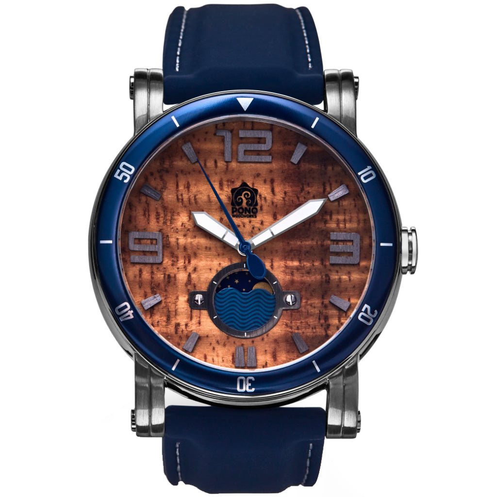 waterman Koa face watch in silver stainless steel showing the design details of water design moon-phase, paddle shaped second hand, sailing winch crown, blue silicone band