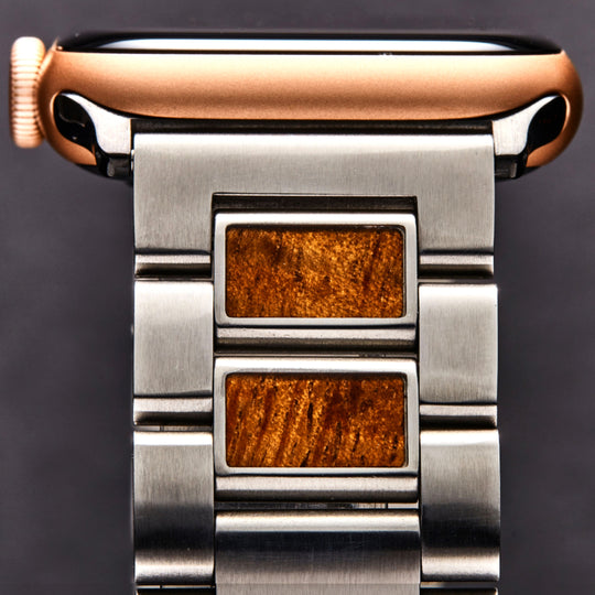 closeup of koa inlay on stainless steel band links and adapter into apple watch