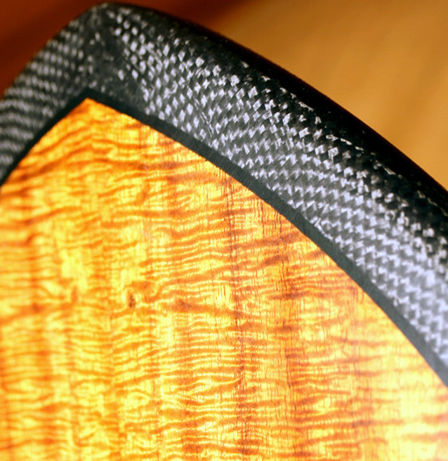 closeup of the koa wood deck and the carbon fiber rails