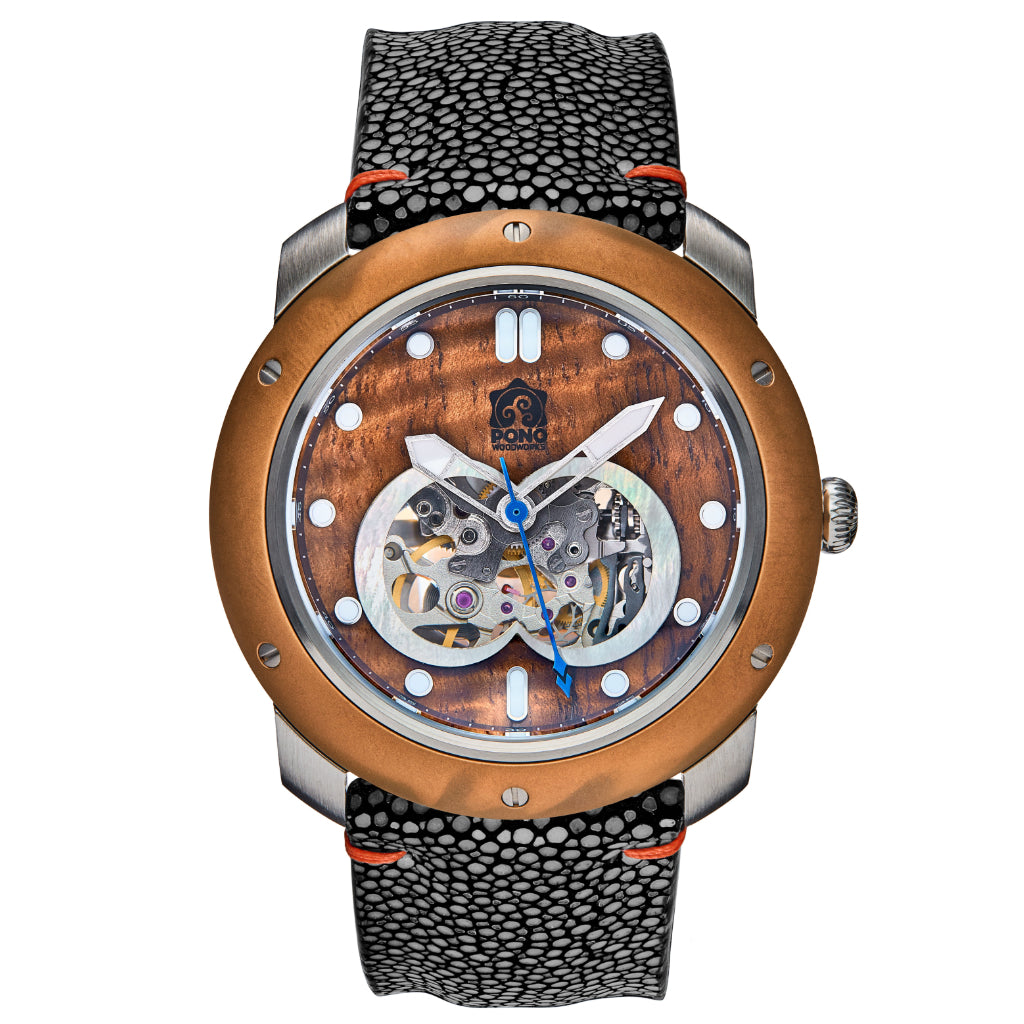 front view of automatic skeleton movement koa wood watch with bronze bezel and silver stainless body, black stingray leather band