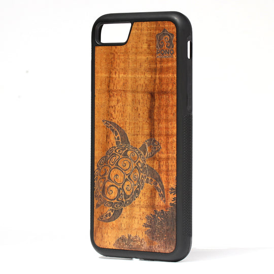 curly koa wood inlay phone case standing upright showing a turtle design laser etched