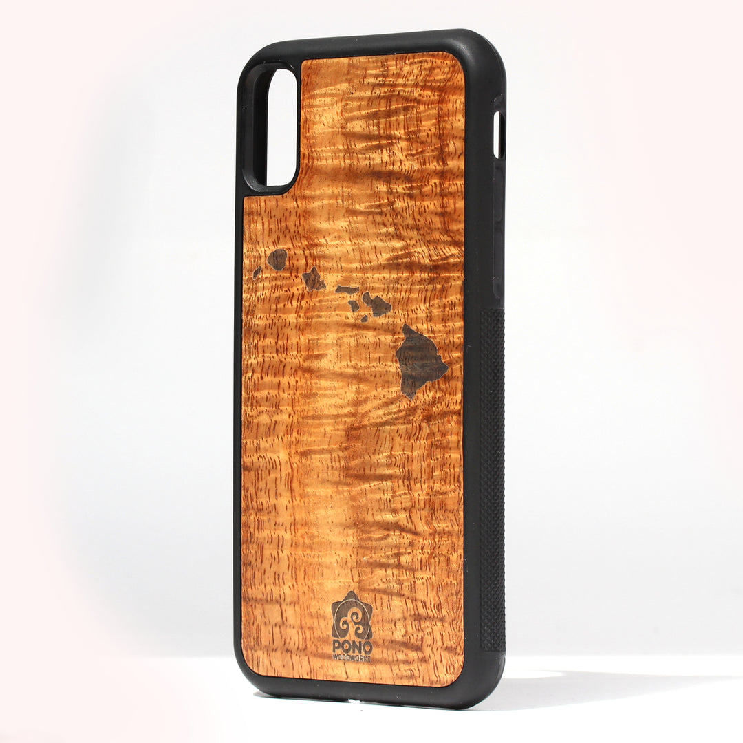 handmade super curly koa wood inlay phone case standing upright showing a Hawaiian island design laser etched