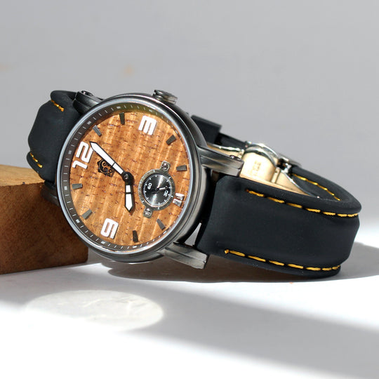 36mm gunmetal koa wood encased watch leaning on block of koa 