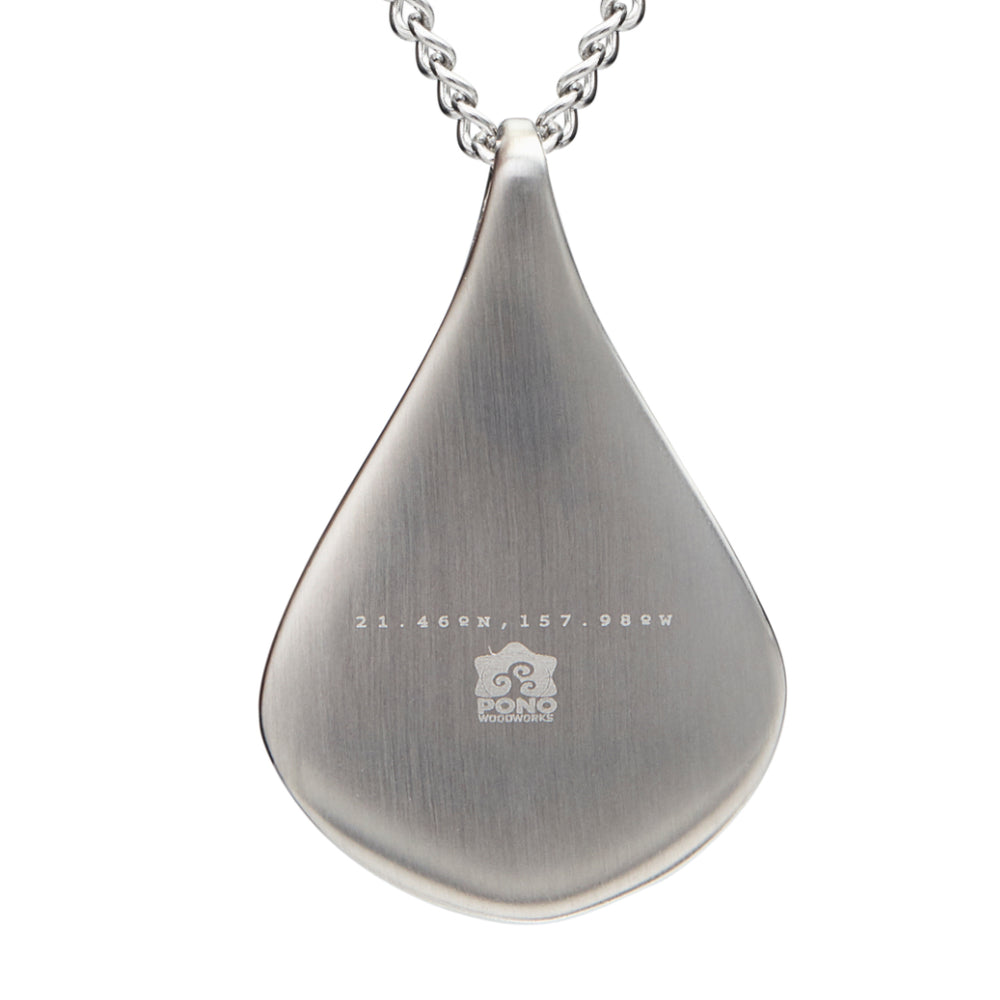 back of koa latitudes pendant showing the logo and latitude and longitude of our shop