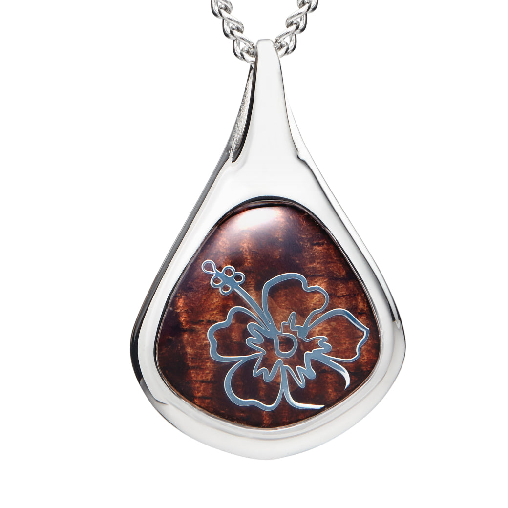 closeup of water-drop shaped pendant inlayed with koa and a hibiscus silver detail